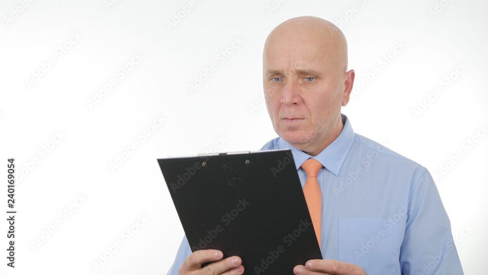 Businessperson Read and Compare Documents from a Clipboard Businessperson Read and Compare Documents from a Clipboard