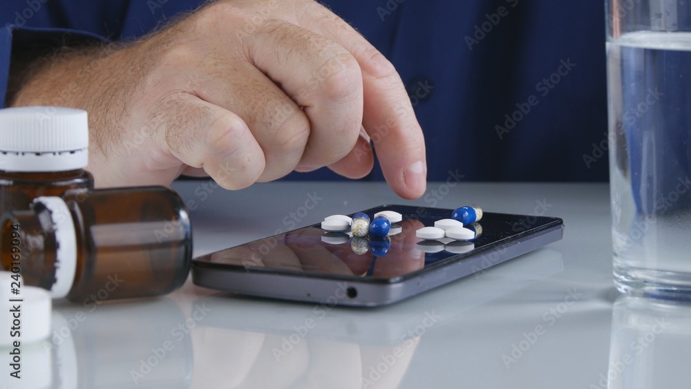 Man Select Medicine Pills from the Smartphone Screen Surface Man Select Medicine Pills from the Smartphone Screen Surface