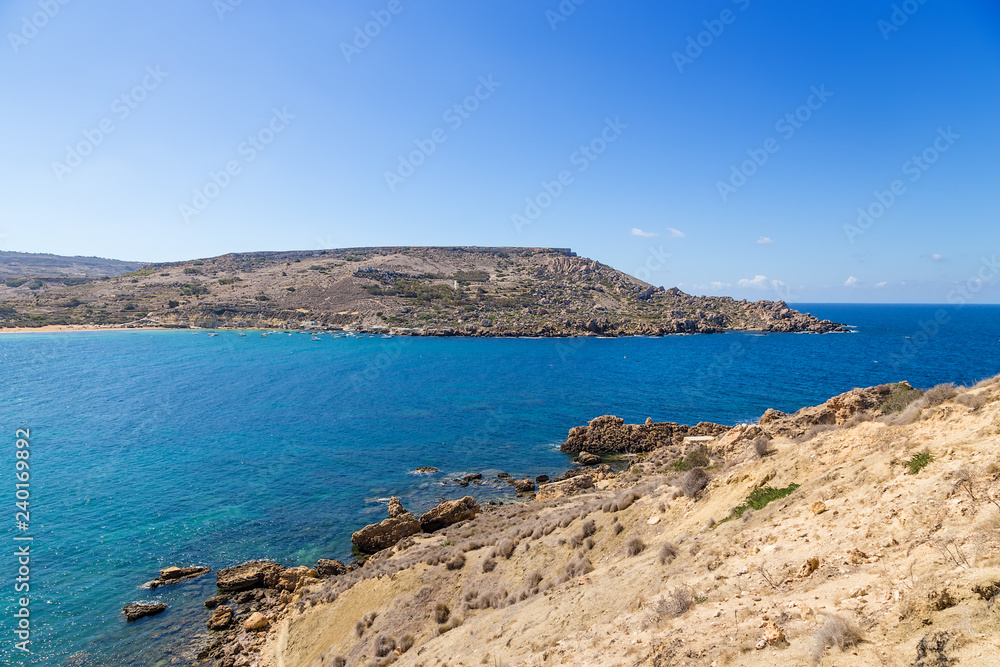 Bay of Gnejna, Malta. Sea, rocks, blue sky Bay of Gnejna, Malta. Sea, rocks, blue sky