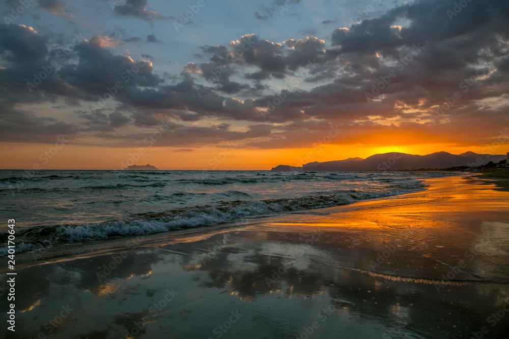 Colorful sunset coastline of the Mediterranean Sea with cloudy sky sunset. Summer sunset.