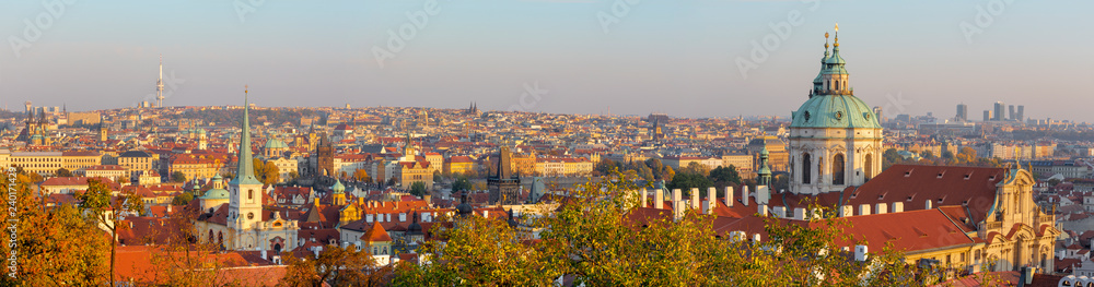 Prague - The panorama of Town with the St. Nicholas church and Charles bridge in evening light.