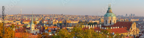 Prague - The panorama of Town with the St. Nicholas church and Charles bridge in evening light.