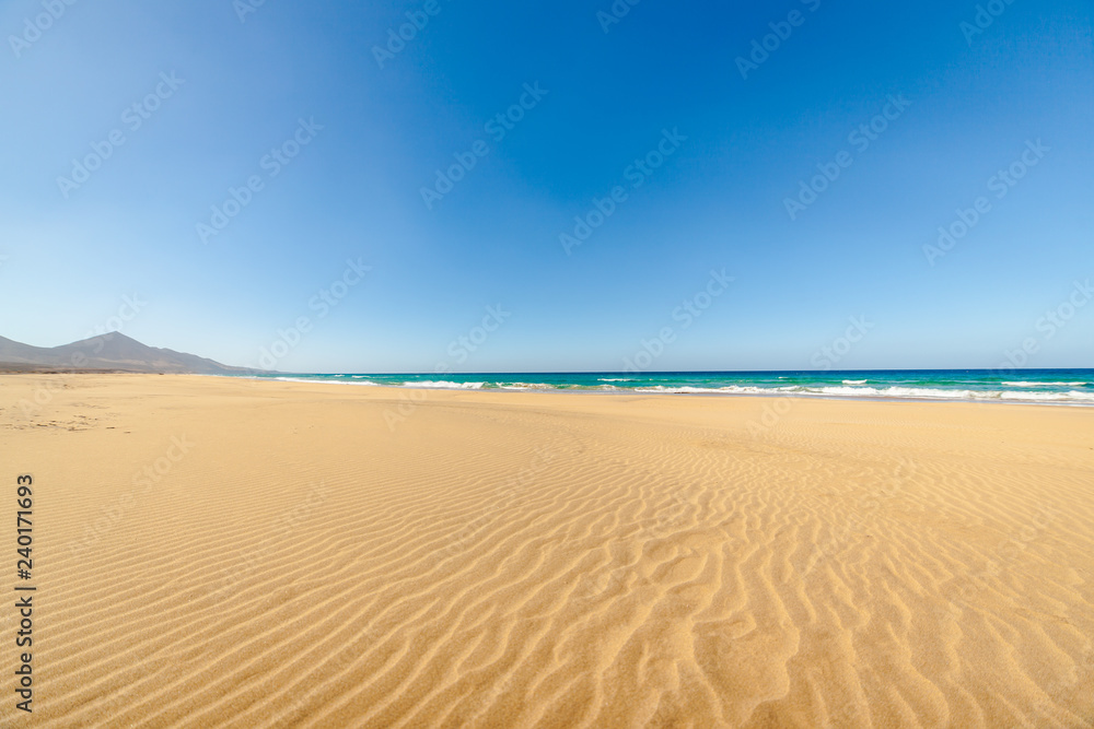 Cofete beach, Fuerteventura, Canary Islands, Spain. Amazing Cofete beach with endless horizon. Volcanic hills in the background and Atlantic Ocean.