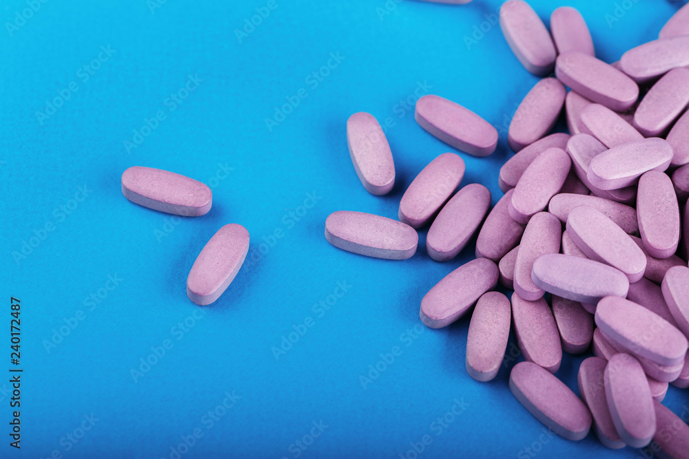 tablets are scattered on a blue background tablets are scattered on a blue background