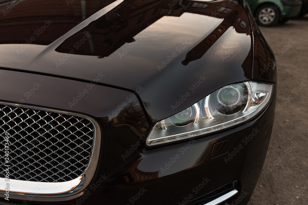 Modern luxury car headlights. Exterior detail.