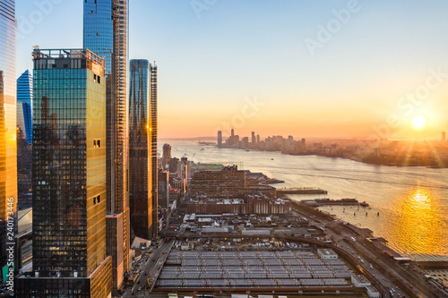 Aerial New York City waterfront skyline at sunset viewed from Hudson Yards towards Jersey City accross Hudson River.