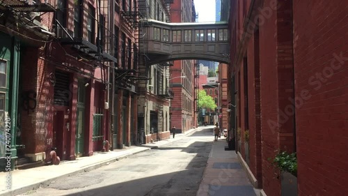 A classic daytime DX establishing shot of empty alley alleyway in New York City Manhattan in summer. Can be used to show suspense, suspicious activity, lofts, shops, danger, lurking