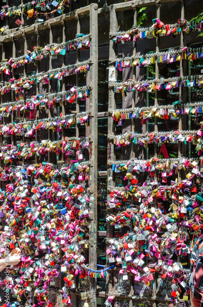 Entrance gate to Juliet's house in Verona. Full of colorful padlocks left by lovers on the promise of respect for mutual love. Concept of loyalty in love.