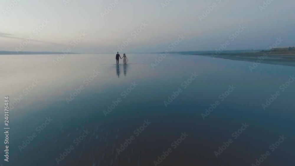 Large body of water. Tourism, ocean travel, Drone view - birds eye angle. Romantic young couple enjoying beautiful sunset walk on the beach travel vacation, Krabi Thailand Large body of water. Tourism, ocean travel, Drone view - birds eye angle. Romantic young couple enjoying beautiful sunset walk on the beach travel vacation, Krabi Thailand