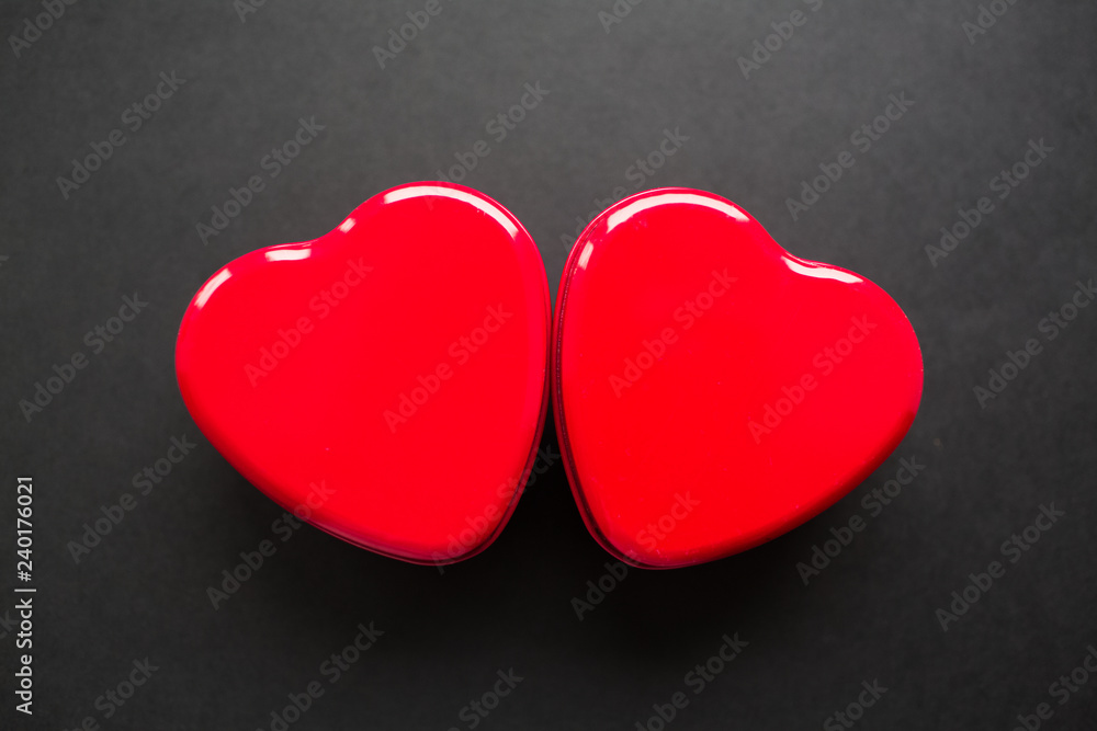 Fototapeta premium Valentines day background. Couple of hearts isolated on black.