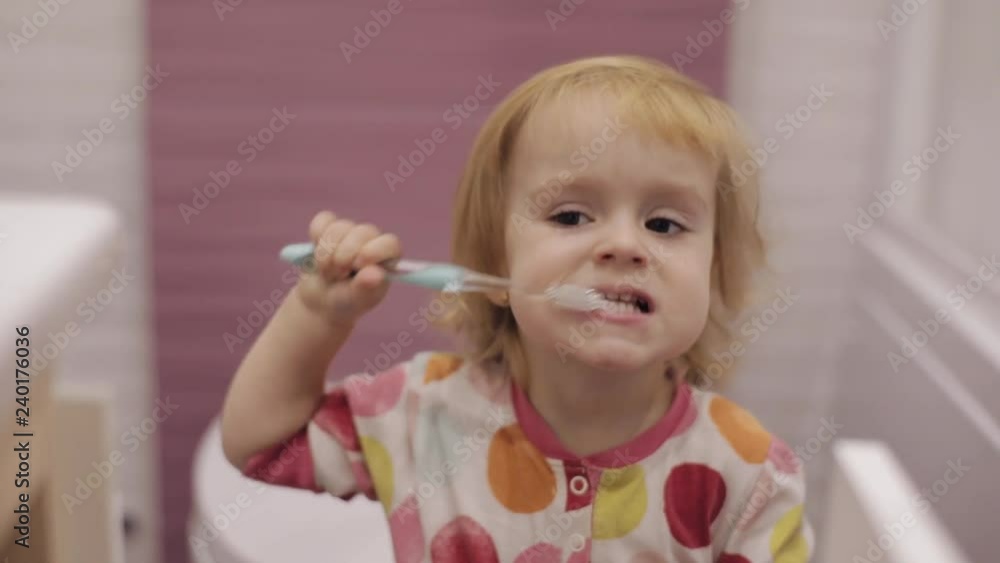 Cute blonde child brush her teeth. Three years old girl. Brown eyes. Few shots! Cute blonde child brush her teeth. Three years old girl. Brown eyes. Few shots!