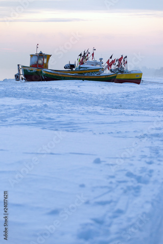 Podmorskie region, Poland - December, 2010: fishing boats on frozen beach, Baltic sea near Sopot town