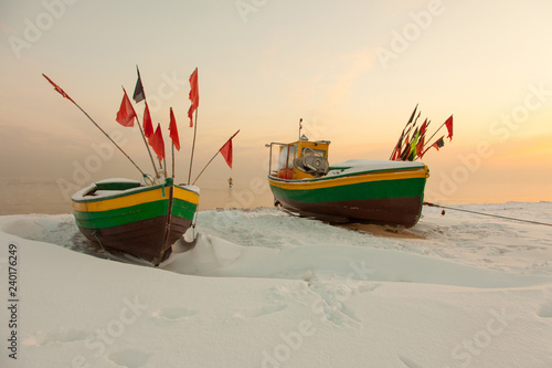 Podmorskie region, Poland - December, 2010: fishing boats on frozen beach, Baltic sea near Sopot town