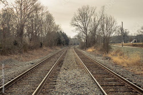 A pair of railroad tracks trailing off into the distance