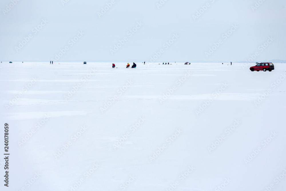 Masuria Region, Poland - January, 2009: anglers on the frozen Sniardwy Lake in winter, Sniardwy is the largest lake in Poland