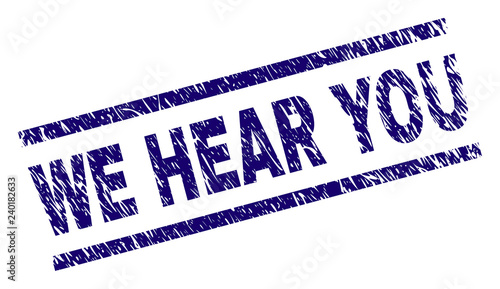 WE HEAR YOU seal print with distress style. Blue vector rubber print of WE HEAR YOU title with retro texture. Text title is placed between parallel lines.