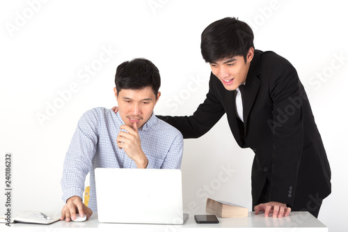 A young CEO touch shoulder his colleague and supporting his engineer for new project. Business mans working and chatting in office. Coworker looking in laptop. Business concept in front view.