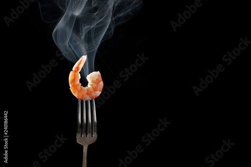 shrimp on fork isolated black background