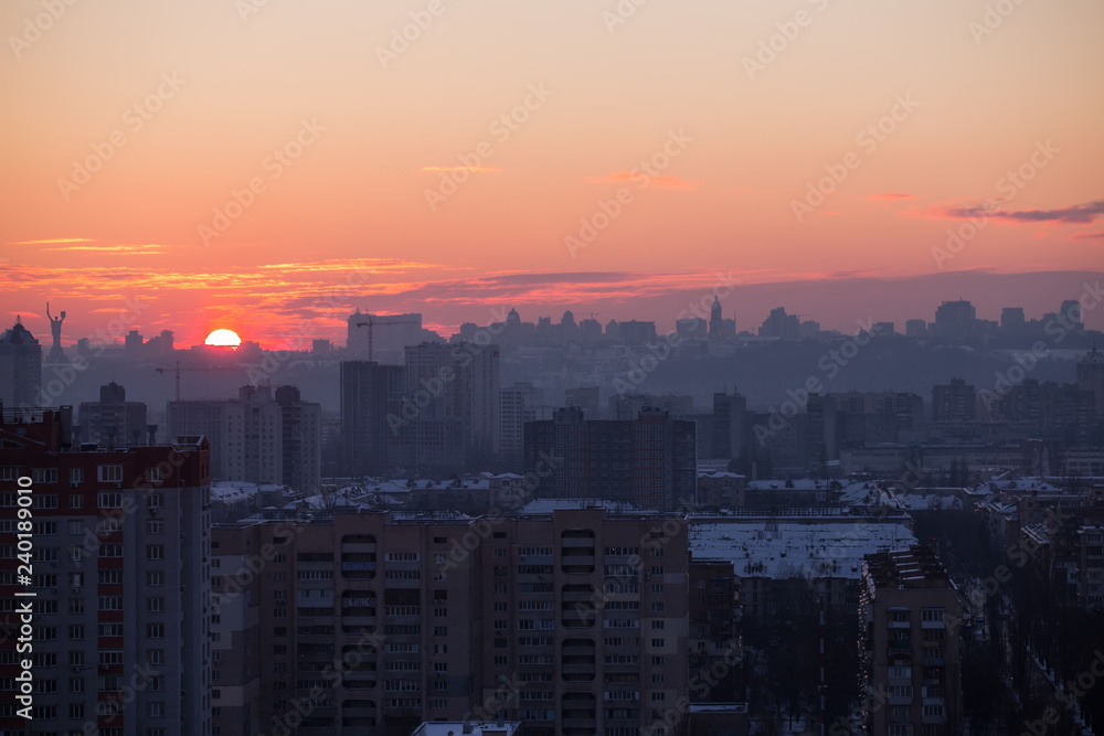 Fototapeta premium Sunset in Kiev, evening view of the panorama of the city, the church and the statue of the Motherland. Evening color urban landscape