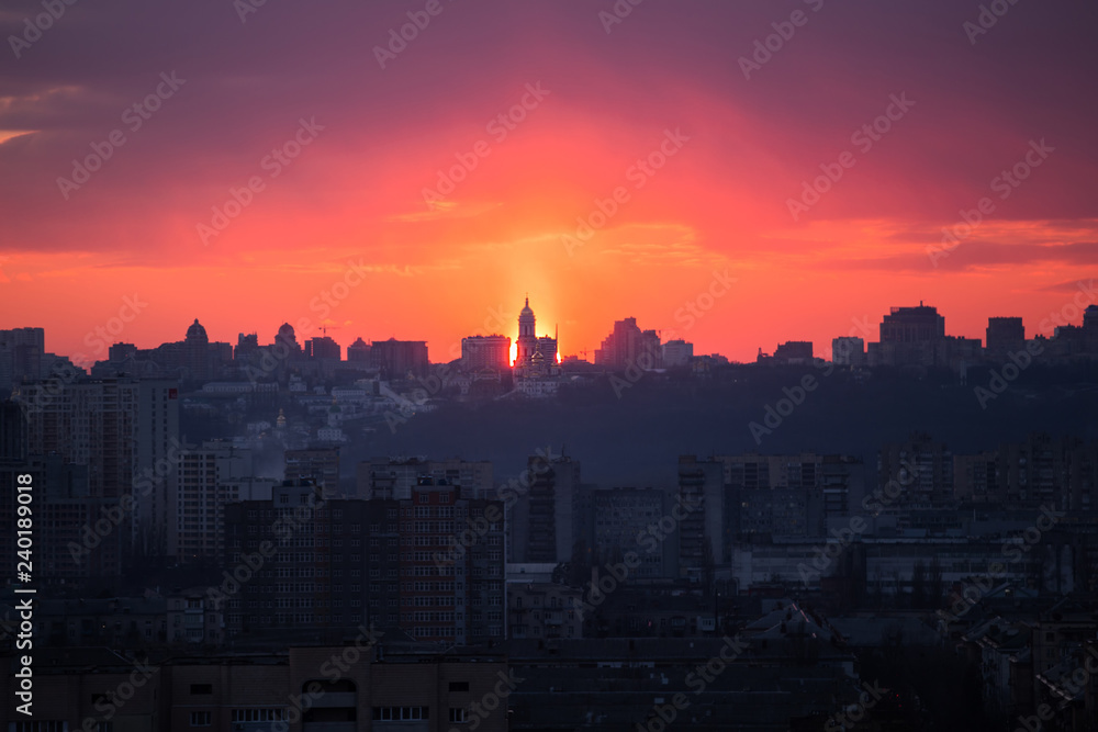 Sunset in Kiev, evening view of the panorama of the city, the church and the statue of the Motherland.  Evening color urban landscape