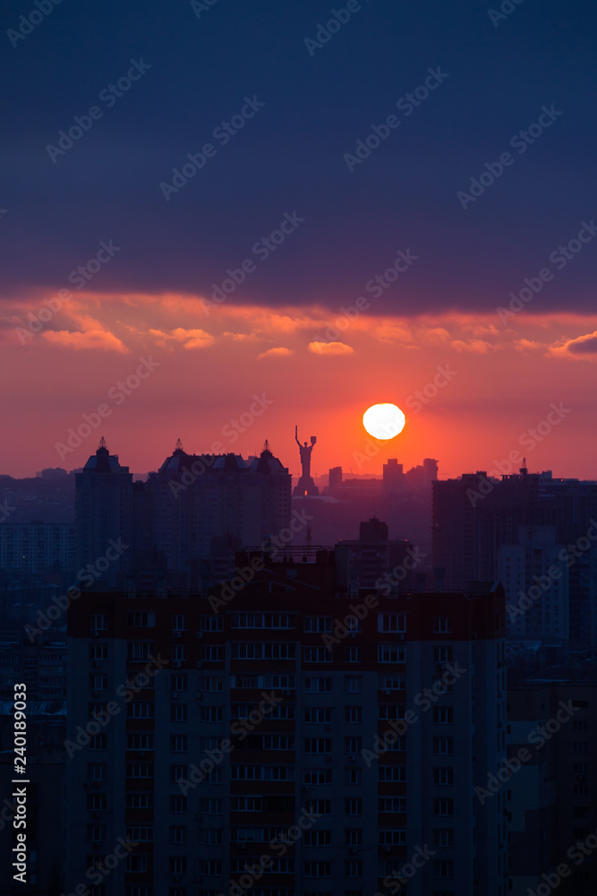 Sunset in Kiev, evening view of the panorama of the city, the church and the statue of the Motherland.  Evening color urban landscape