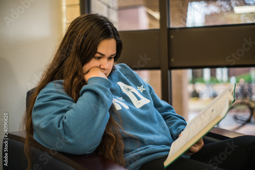 College girl reading textbook