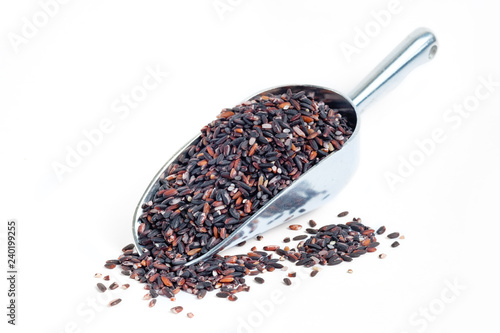 Black glutinous rice on metal scoop and white background
