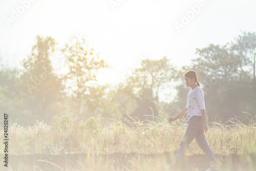 Women walking in rice fields at sunset