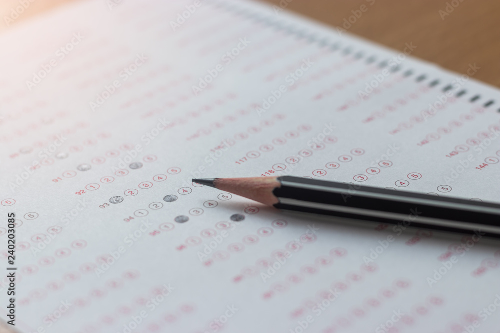 Black pencil on paper computer sheet. Standardized test form with answers bubble. Multiple choice answer sheets. Ideas about education. Black pencil on paper computer sheet. Standardized test form with answers bubble. Multiple choice answer sheets. Ideas about education.