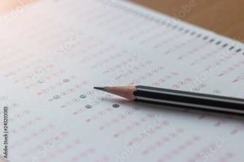 Black pencil on paper computer sheet. Standardized test form with answers bubble. Multiple choice answer sheets. Ideas about education.