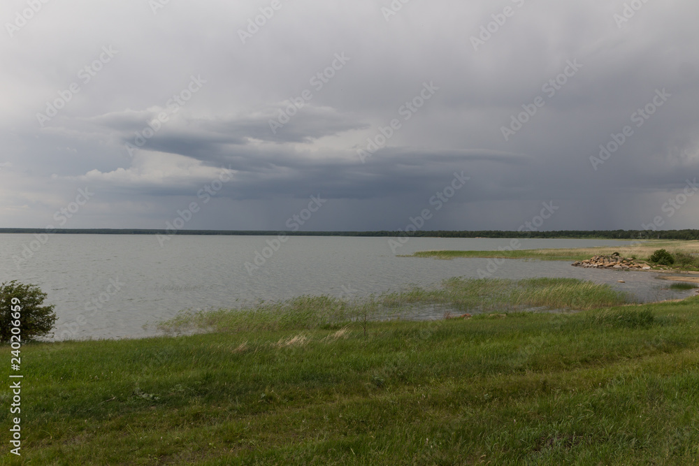 landscape with lake and dark sky