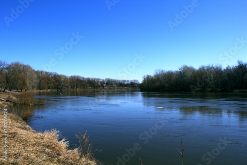 River banks. Water and trees. Springtime.