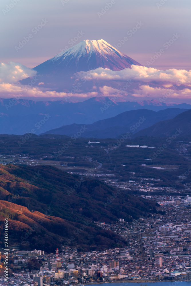 Sunset of Mt. Fuji covered with city view by snow from Nagano in winter