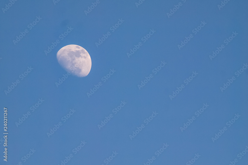moon in evening time on beautiful natural blue sky background moon in evening time on beautiful natural blue sky background