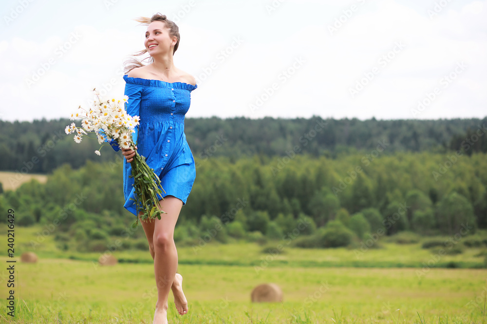 Young cute girl run in a field at sunset Young cute girl run in a field at sunset