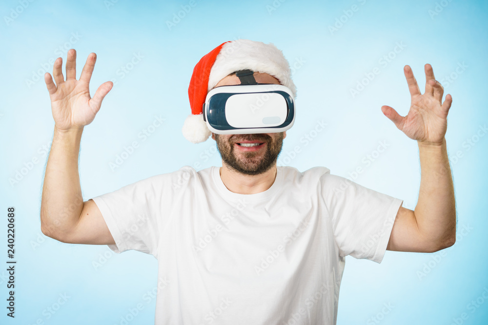 Man in virtual reality goggles and santa hat Man in virtual reality goggles and santa hat