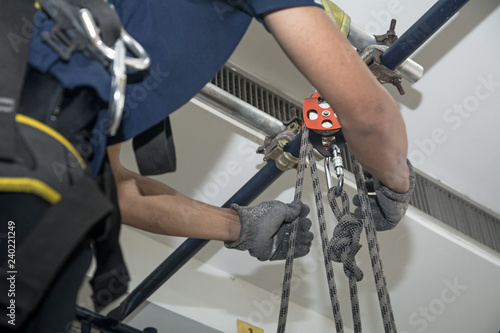 The man set up a Snatch Blocks or wire rope pulleys in factory