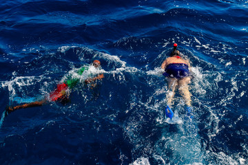 Foto auf Acrylglas Tauchen Group of people snorkeling over the coral reef in the Red Sea  © olyasolod