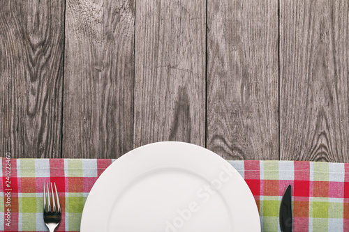 Tablecloth and cutlery on a wooden table with copy space. Food background