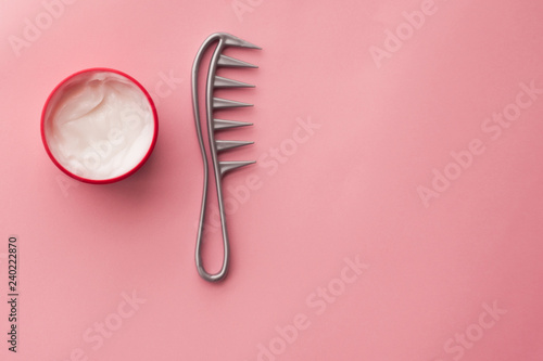 hair mask and hairbrush on a pink background. hair care. hair lamination. selective focus. milk in cosmetic jars 