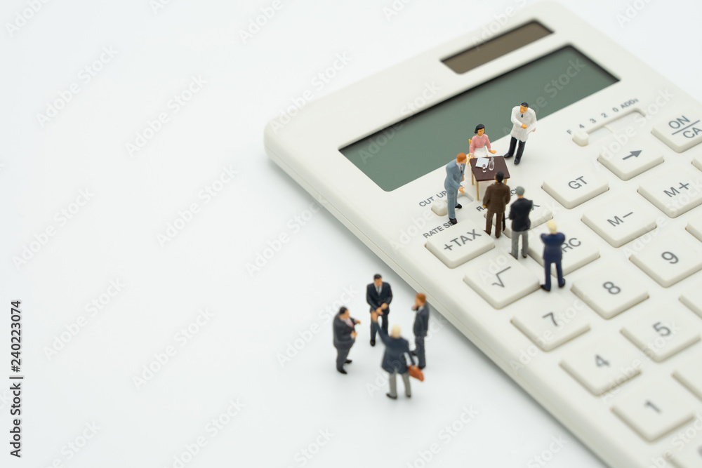 Miniature people Pay queue Annual income (TAX) for the year on calculator. using as background business concept and finance concept with copy space for your text or design. Miniature people Pay queue Annual income (TAX) for the year on calculator. using as background business concept and finance concept with copy space for your text or design.