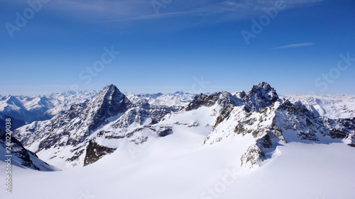 winter mountain landscape in the Alps of Switzerland with peaks and glaciers