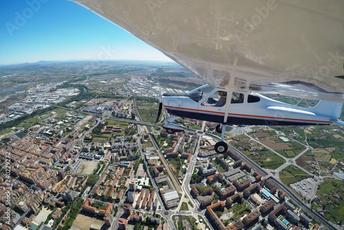 PILOT FLYING ABOVE A CITY WITH A AIRPLANE