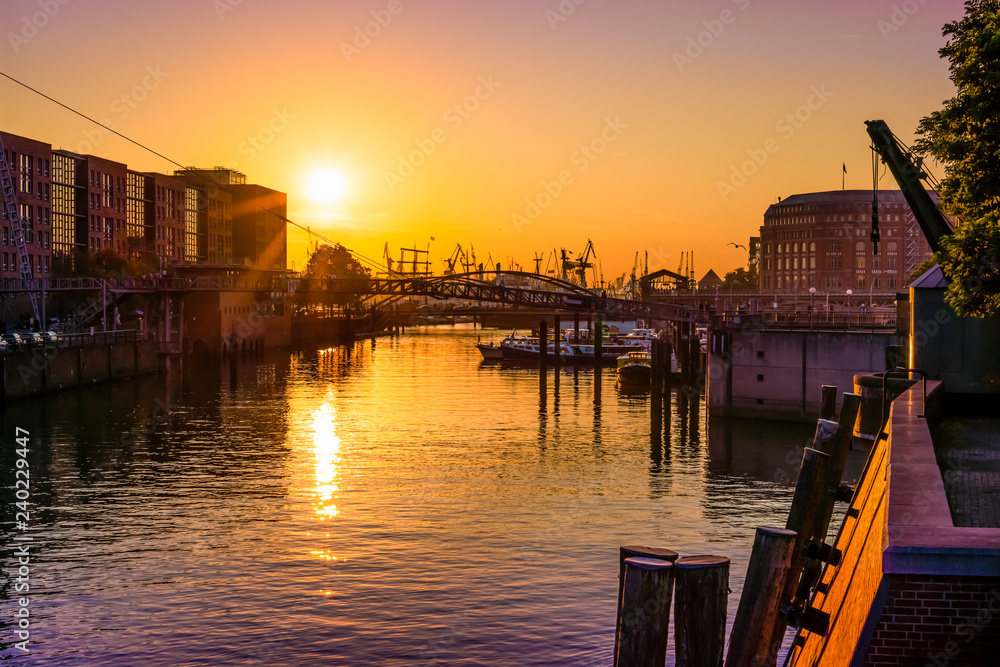 Sundown in Hamburg Harbor, Germany, reflecting in the river Elbe.