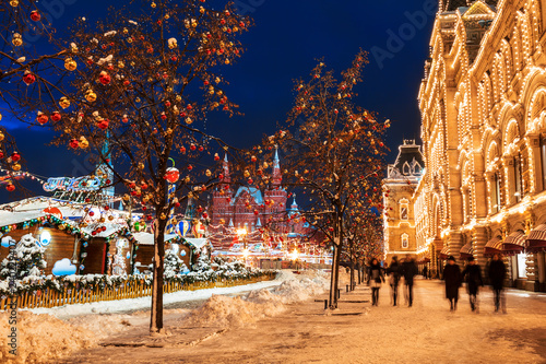 Winter Moscow, tourists are walking on Red Square near GUM in the evening. Russia