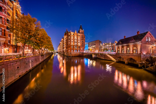 The Warehouse District (German: Speicherstadt) in Hamburg, Germany at night. The largest warehouse district in the world is located in the port of Hamburg within the HafenCity quarter.