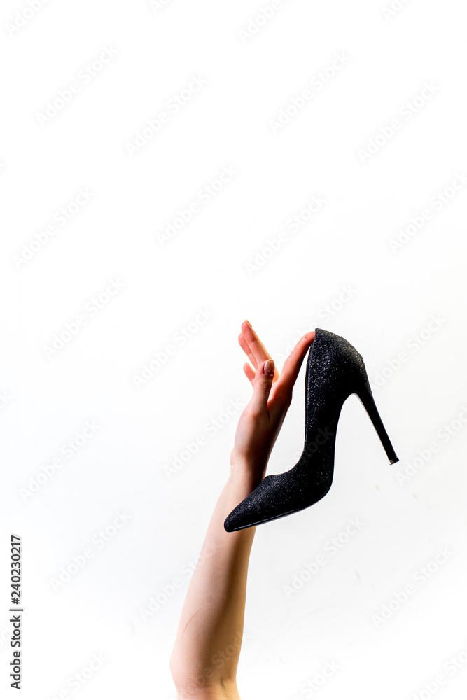 Female hands holding fashionable high heel shoes Female hands holding fashionable high heel shoes