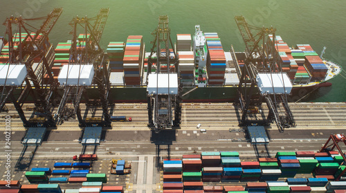 Aerial footage commercial logistics industry. The containers is loaded / unloaded at Kwai Tsing Container Terminals Of Hong Kong. photo