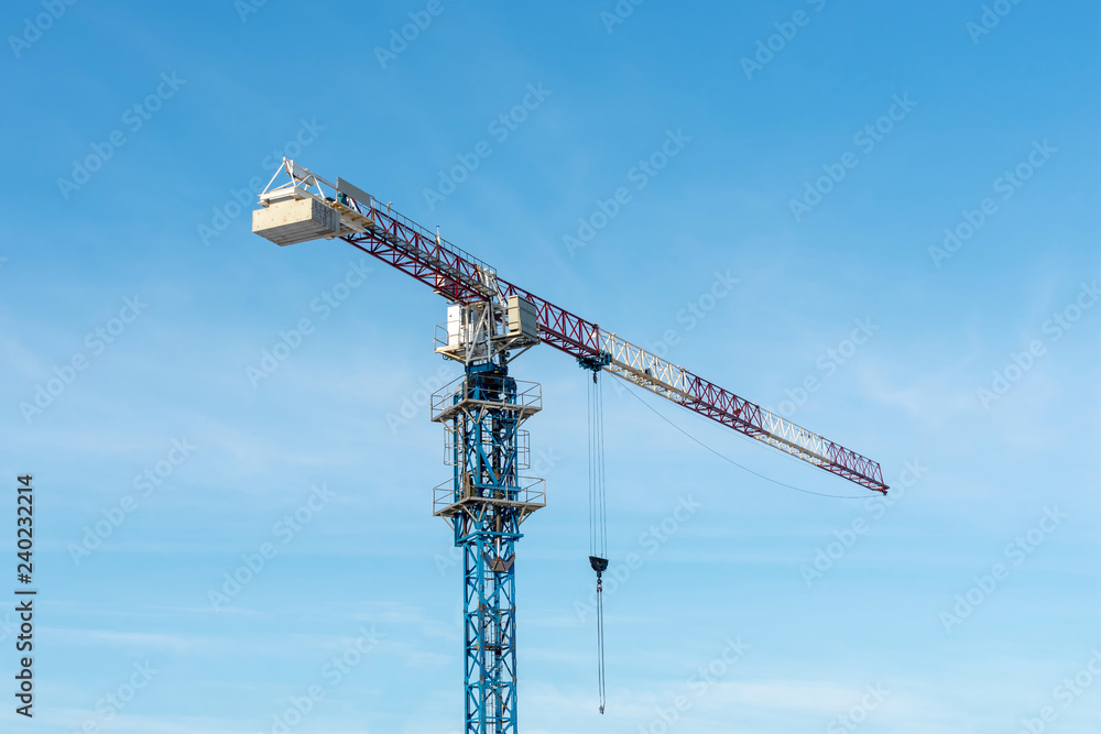 Jib crane. Construction crane against blue sky. Jib crane. Construction crane against blue sky.