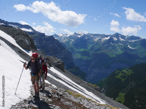 mountain climbers heading to the foot of Eiger and Moench mountain peaks in the Swiss Alps near Grindelwald